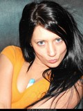 Dark haired chick Andi plays with her nipples before stripping out of her dress