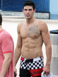 Adam Gregory with sexy tattooed muscle torso caught topless on a beach resort