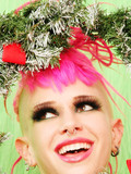 Alt chick with rich make-up and pink hair shows her tattoos and naughty bits