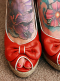 Lady takes off her sheer pantyhose and shows off her tattooed feet and painted toenails