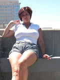 Chubby middle aged woman takes off her jean shorts and shows her snatch on the roof