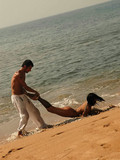 Nude obedient brunette gets mouth fucked and takes brutal guy's cock in her pussy in sand