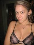 Cute faced girlfriend pulls off her revealing black bra and shows her shapely boobs