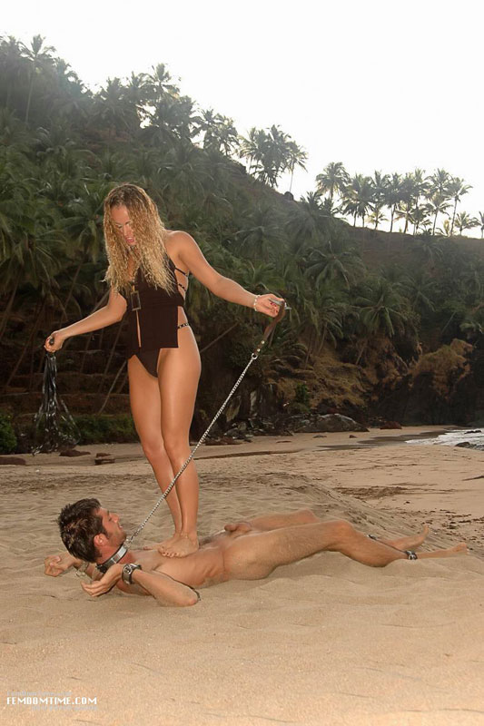 Nude leashed male slave gets dominated by clothed blonde on a deserted beac...
