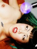Tattooed slim brunette babe in black nylons gets her hard nipples tortured