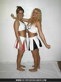Flirty blonde cheerleader in black and white uniform posing and flashing her panties