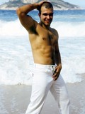 Male model with hairy chest gets his dick out while posing on the beach