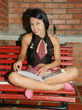Young latina girl Gigi removes her panties but leaves her red short skirt