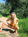 Sweet blonde girl spreads her legs and pisses in the middle of the country road