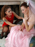 The horny bridesmaid in red dress wants to console the friend and kisses her tenderly