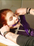 Tied up redhead in stockings, skirt, blouse and heels left helpless in the bathtub