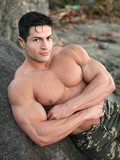 Incredibly strong man with big iron muscles poses outdoors and shows his nice bare ass