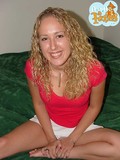 curly-haired-blonde-girl-gets-naked-on-a-bed-and-shamelessly-shows-her-small-tits