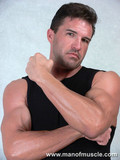 dark-haired-handsome-man-with-sexy-muscled-torso-goes-topless-for-your-excitement