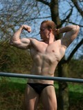 man-flashes-his-ass-while-showing-off-his-muscles-outdoors-at-spring-time