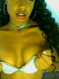 Sex dressed exotic girl shows her slim bare belly and makes her black eyes on you