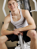 Topless young guy show his skinny torso while changing his clothes and doing exercises at the gym