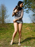 Brunette girl with beautiful slim legs lifts her short dress up to pee outdoors