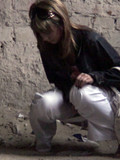Brown haired girl in white jeans and panties caught peeing in deserted place