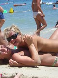 playful-blonde-chick-bares-her-tits-and-has-lesbian-fun-with-her-friend-on-the-beach