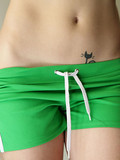 Brown haired rookie takes off her green shorts and pulls down her black panties to flash her tattoo