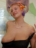 elegant-blonde-woman-in-black-dress-shows-her-playful-smile-big-tits-and-new-hair-style