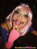 Pink haired thai girl with rich make-up flashes her smooth tight pussy playfully