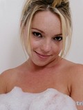 Tasty blonde spreads her shaved pink pussy open before taking a bubble bath